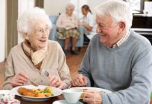 Elderly couple enjoying a meal together in a dining room