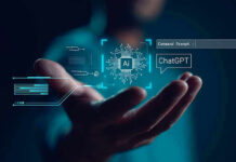 Hand holding digital AI and ChatGPT graphics.