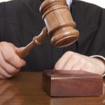 Tiger King Lawyer SANCTIONED — AI Lies Exposed A judge holding a gavel above a wooden block