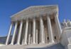 Birthright Citizenship On Trial—Supreme Court Shock The Supreme Court building featuring grand columns and statues under a clear blue sky