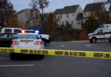 Man Bulldozes Family Home After Marital Bust-Up Sheriff line tape blocking scene with police and ambulance.