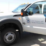 Border Chief’s Shocking Exit Amid Scandal U.S. Customs and Border Protection truck with open door.