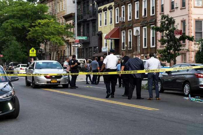 1437619223-1 Police gathered at an urban crime scene.