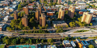 Aerial view of urban area with tall buildings and freeway.