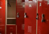 Virginia Schools’ SHOCKING Trans Locker Room Controversy Red lockers with padlocks, one open with hanger.
