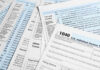 Tax forms and documents overlapping on surface