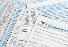 $1,000 PER CHILD: Secret Savings Program Unveiled! Tax forms and documents overlapping on surface