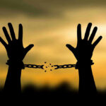 Governor Slashes Sentence—Shocking Election Clerk Release Hands breaking free from chains at sunset.