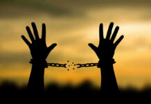 Governor Slashes Sentence—Shocking Election Clerk Release Hands breaking free from chains at sunset.
