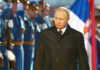 Putin’s SHOCKER: Ukraine War Nears End? A man in dark coat at a military event.