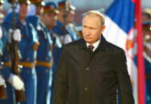 Putin’s SHOCKER: Ukraine War Nears End? A man in dark coat at a military event.