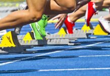 Transgender Athlete Sparks Major Controversy Athletes starting a sprint from starting blocks on a blue track