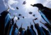 AI Speech BACKFIRES: Former Google CEO Booed Graduating students celebrating by throwing their caps into the air under a bright blue sky