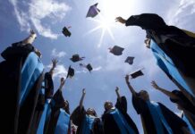 AI Speech BACKFIRES: Former Google CEO Booed Graduating students celebrating by throwing their caps into the air under a bright blue sky