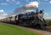 Border Rail Tragedy: Six Found Dead in Boxcar A vintage steam locomotive pulling passenger cars on a railway track