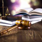 Backpack Search Controversy: Could This Set a Killer Free? A gavel, legal books, and scales of justice on a wooden table