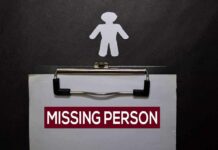 Clipboard with a missing person notice and a paper cutout figure