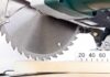 Close-up of a circular saw blade cutting through a piece of wood
