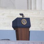 Rubio’s Unexpected Surge Challenges MAGA Heir Podium with a microphone and presidential seal in front of steps
