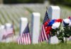 Arlington’s Secret: 260K Flags in Hours American flags and flowers placed at graves in a cemetery
