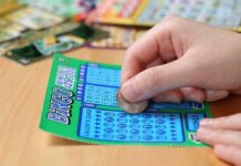 Karma Strikes: Lottery Ticket Return Sparks $586K Win A person scratching off a bingo lottery ticket with a coin