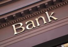 Trump’s Bank Order Sparks Immigration FIRESTORM Close-up of a bank sign with gold lettering