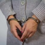 Utah Mom’s Shocking Betrayal: Poisoned Husband, Terrified Kids A person wearing handcuffs with their hands clasped together