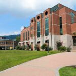 Donor’s Shocking Move: $2 Million Debt Erased Modern educational building on a college campus with landscaped grounds