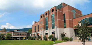Modern educational building on a college campus with landscaped grounds