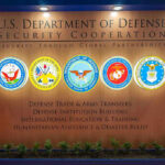 $6B Vanishes Into Nowhere? U.S. Department of Defense Security Cooperation display with logos.