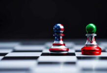Hormuz Reopens, Nukes Deferred Chess pieces with USA and Iran flags on board.
