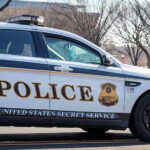 United States Secret Service police car on roadside.