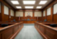 Track Meet Turns Deadly—Verdict Stuns Empty courthouse courtroom with wooden benches and chairs.