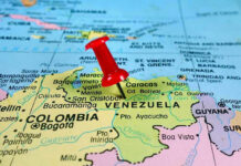 Venezuela Strike: Trump Claims Cartel Boss Down Red pin on Venezuela, South America map.