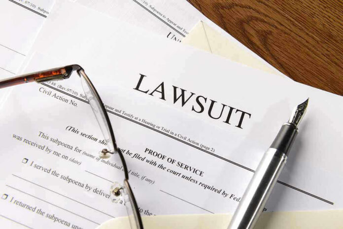 334984952 Lawsuit papers with glasses and pen on table.