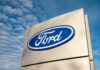 White House Curveball Rattles Ford, GM Ford logo sign against blue sky.