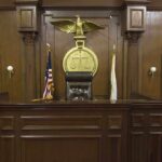 9–0 Shock: Marijuana Users Keep Guns Interior of a courtroom featuring a judges bench and American flag