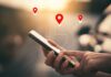 Supreme Court Slaps Digital Dragnets Person using a smartphone with location markers displayed on the screen