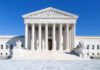 DOJ Bombshell: SPLC Cash To Neo-Nazi Insider? The Supreme Court building featuring marble columns and a clear blue sky