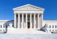 DOJ Bombshell: SPLC Cash To Neo-Nazi Insider? The Supreme Court building featuring marble columns and a clear blue sky