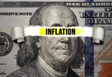 Inflation Shock: Three-Year High Looms A torn paper strip with the word 'INFLATION' over a hundred dollar bill featuring Benjamin Franklin