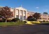 Facebook Threats Jolt Catholic School Exterior view of a brick school building with yellow steps and a cross on top