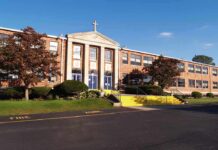 Facebook Threats Jolt Catholic School Exterior view of a brick school building with yellow steps and a cross on top