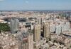 Rent Freeze Backfires? NYC’s Cost Time Bomb Aerial view of a sprawling urban city with high-rise buildings and green spaces