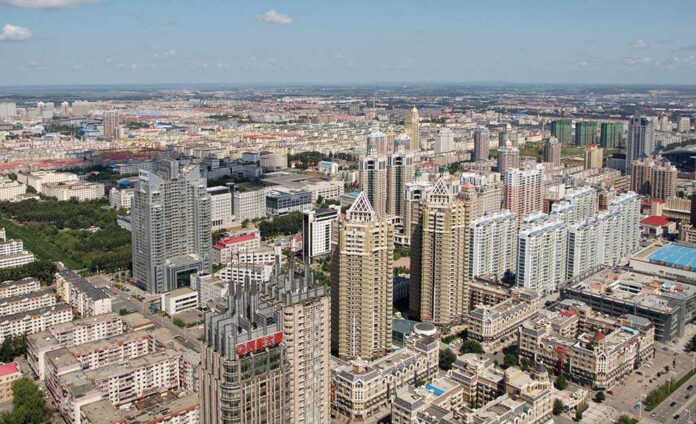 Aerial view of a sprawling urban city with high-rise buildings and green spaces