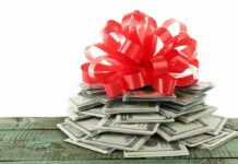 Fake Charity, Real Terror Money A stack of cash topped with a red ribbon bow