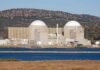 Iran Dismantles Nukes? Not So Fast Nuclear power plant with domed structures beside a water body and mountains in the background