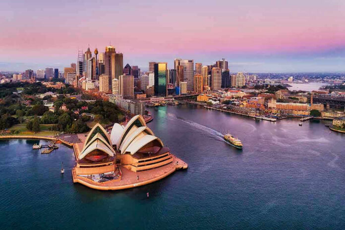 1094901527 Sydney Opera House and city skyline at sunset.