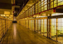 Deadly Prison Riot Exposes Rotten System Empty hallway between rows of prison cells.