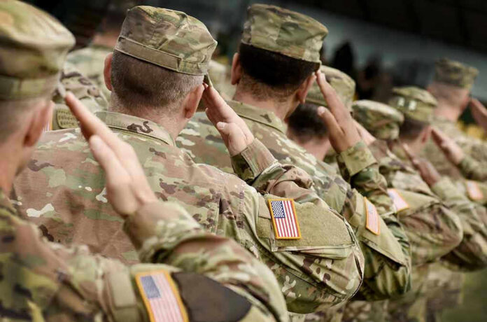 1548712049 Soldiers in camouflage uniforms saluting in formation outdoors
